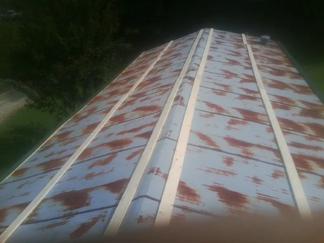 Rusted metal roof panels with new wood purlins before replacement — Storm Damage Roof Repair in Oak View by Roofing Brothers